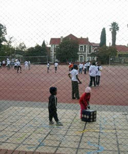 Children at the park using the new volleyball and basketball courts